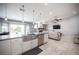Open floor plan with living area featuring tile flooring, ceiling fan, and access to the outdoor space at 6417 Fisher Ave, Las Vegas, NV 89130