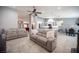 Spacious open floorplan with living room flowing into the kitchen, featuring a stone fireplace and tile floors at 6417 Fisher Ave, Las Vegas, NV 89130