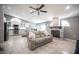 Open living space connecting kitchen and living room, tile flooring, stone fireplace and contemporary design at 6417 Fisher Ave, Las Vegas, NV 89130