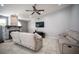 Comfortable living room featuring tile floors, ceiling fan, stone fireplace and neutral décor at 6417 Fisher Ave, Las Vegas, NV 89130
