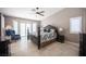 This main bedroom features a shuttered window, dark wood furniture, and a ceiling fan at 6417 Fisher Ave, Las Vegas, NV 89130