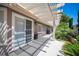 Spacious covered patio with a sliding glass door and lush landscaping at 6417 Fisher Ave, Las Vegas, NV 89130
