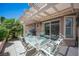 Inviting outdoor patio area with a dining table, grill, and view of the surrounding greenery at 6417 Fisher Ave, Las Vegas, NV 89130