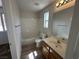 Bathroom featuring a single vanity, mirror, and tiled shower and tub at 7282 Quarterhorse Ln, Las Vegas, NV 89148