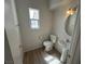 Half bathroom with wood-look flooring, pedestal sink, and natural light at 7282 Quarterhorse Ln, Las Vegas, NV 89148