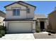 Two-story home featuring a two-car garage, neutral stucco, and a well-maintained yard at 7282 Quarterhorse Ln, Las Vegas, NV 89148