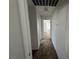Hallway with carpet, leading to a bright room with natural light at 7282 Quarterhorse Ln, Las Vegas, NV 89148