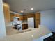 Kitchen with white appliances, breakfast bar, and wood cabinets at 7282 Quarterhorse Ln, Las Vegas, NV 89148