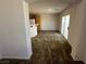 Carpeted living room with sliding glass door leading to the backyard at 7282 Quarterhorse Ln, Las Vegas, NV 89148