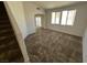 Spacious carpeted living room with ample natural light and an archway to another room at 7282 Quarterhorse Ln, Las Vegas, NV 89148