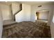 Open living area with carpet and easy access to kitchen and staircase at 7282 Quarterhorse Ln, Las Vegas, NV 89148