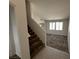 View of the living room with carpet flooring and natural light from multiple windows at 7282 Quarterhorse Ln, Las Vegas, NV 89148