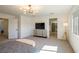 Bright main bedroom featuring modern lighting, a comfortable bed, and an entrance to the en suite bathroom at 7499 Lodano Ave, Las Vegas, NV 89113