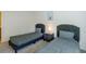 Comfortable bedroom featuring two twin beds with stylish headboards and a central nightstand at 7499 Lodano Ave, Las Vegas, NV 89113