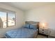 Comfortable bedroom featuring a large window and modern furnishings at 7499 Lodano Ave, Las Vegas, NV 89113