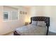 Cozy bedroom with a comfortable bed, soft carpet, a window with a view, and neutral walls at 7499 Lodano Ave, Las Vegas, NV 89113