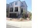 Two-story home featuring a balcony, two-car garage, and brick paved driveway at 7499 Lodano Ave, Las Vegas, NV 89113