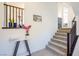 Inviting foyer featuring staircase and stylish console table with decorative accents at 7499 Lodano Ave, Las Vegas, NV 89113