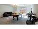 Spacious game room with a pool table, comfortable seating, and natural light at 7499 Lodano Ave, Las Vegas, NV 89113