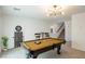 Well-appointed game room with a pool table, dartboard, and comfortable seating for entertainment at 7499 Lodano Ave, Las Vegas, NV 89113