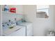 Well-lit laundry room equipped with modern appliances and ample storage space at 7499 Lodano Ave, Las Vegas, NV 89113