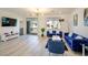 Bright living area featuring modern decor, wood flooring and TV set up at 7499 Lodano Ave, Las Vegas, NV 89113