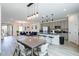 Bright open-concept living space featuring a modern kitchen and dining area perfect for entertaining guests at 7499 Lodano Ave, Las Vegas, NV 89113