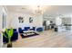 Bright, open-concept living area with modern decor and wood flooring and open concept to the kitchen at 7499 Lodano Ave, Las Vegas, NV 89113