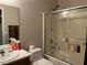 A functional bathroom featuring a shower-tub combo, standard fixtures, and a sliding glass door at 7812 Sedalia St, Las Vegas, NV 89139