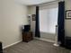 A carpeted bedroom with simple furnishings and a neutral color scheme and a large window at 7812 Sedalia St, Las Vegas, NV 89139