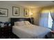 A well-lit bedroom with a large bed, window, and dresser, offering a relaxing space at 7812 Sedalia St, Las Vegas, NV 89139