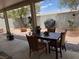 Covered patio with an outdoor dining set and a gravel backyard enclosed by a block wall at 7812 Sedalia St, Las Vegas, NV 89139