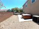 Backyard featuring gravel landscaping, an outdoor spa, and a privacy wall at 8340 Winterchase Pl, Las Vegas, NV 89143