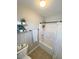 Bathroom with tub-shower combo, tile flooring, towel bar, and decor shelves at 8340 Winterchase Pl, Las Vegas, NV 89143