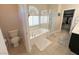 Well-lit bathroom with a soaking tub, shower, and toilet, providing a serene space to relax at 8340 Winterchase Pl, Las Vegas, NV 89143
