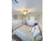 Bedroom with floral bedding, ceiling fan, wainscoting, and white trim at 8340 Winterchase Pl, Las Vegas, NV 89143