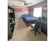 Nicely decorated bedroom with baseball theme, ceiling fan, desk, and modern gaming chair at 8340 Winterchase Pl, Las Vegas, NV 89143