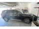 Garage featuring a black SUV and overhead storage, on a concrete floor at 8340 Winterchase Pl, Las Vegas, NV 89143