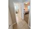 Hallway view into bathroom and bedroom showcasing a neutral color scheme and tile floors at 8340 Winterchase Pl, Las Vegas, NV 89143