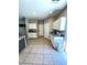 Well-lit kitchen featuring white cabinets, tiled floors, and modern appliances at 8340 Winterchase Pl, Las Vegas, NV 89143