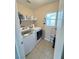 Functional laundry room with washer, dryer, and storage shelves at 8340 Winterchase Pl, Las Vegas, NV 89143