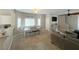 Spacious living area with large windows, a ceiling fan, and neutral color palette at 8340 Winterchase Pl, Las Vegas, NV 89143
