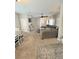 Open living space with comfortable seating, ceiling fan, and neutral carpeting at 8340 Winterchase Pl, Las Vegas, NV 89143