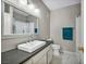 Bathroom featuring a square sink with silver faucet, sleek dark countertops, and an ornate mirror at 8501 W University Ave # 1083, Las Vegas, NV 89147