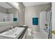 Bathroom features bright natural light, a bathtub with shower, and blue towels hanging on a towel rack at 8501 W University Ave # 1083, Las Vegas, NV 89147