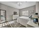 Inviting bedroom with wood-look flooring, decorative rug, bright natural light, and a dresser at 8501 W University Ave # 1083, Las Vegas, NV 89147