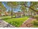 A lush lawn area is accented by a barbecue grill, picnic table, and shady pavilion at 8501 W University Ave # 1083, Las Vegas, NV 89147