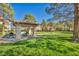 A well-maintained community space offers a barbecue grill, picnic table, and shady pavilion at 8501 W University Ave # 1083, Las Vegas, NV 89147