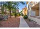An apartment complex with mature trees, lush greenery, and clean walking paths at 8501 W University Ave # 1083, Las Vegas, NV 89147