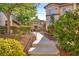 Well-maintained landscaping featuring green shrubbery and stone pathway up to the building at 8501 W University Ave # 1083, Las Vegas, NV 89147